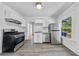 Charming kitchen with stainless appliances, white cabinets, and a window view at 1685 Carroll Nw Dr, Atlanta, GA 30318