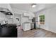Bright kitchen with stainless steel appliances, white cabinets and wood look flooring at 1685 Carroll Nw Dr, Atlanta, GA 30318