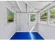 Cozy sunroom with painted floors, plenty of sunlight, and a door to the outside at 1685 Carroll Nw Dr, Atlanta, GA 30318