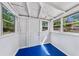 Sunroom with white walls, bright blue floor, and large windows that let in natural light at 1685 Carroll Nw Dr, Atlanta, GA 30318