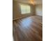 An empty bedroom with wood floors and a window lets in plenty of natural light at 2763 Storybook Ct, Grayson, GA 30017