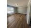 A large bedroom is painted gray and features wood floors for a modern and clean look at 2763 Storybook Ct, Grayson, GA 30017