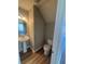 A half bath features a pedestal sink, oval mirror, gray walls and wood flooring at 2763 Storybook Ct, Grayson, GA 30017