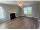 Inviting living room with hardwood floors, a classic fireplace, and large windows providing ample natural light at 2763 Storybook Ct, Grayson, GA 30017