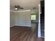 Bright and spacious living room featuring a ceiling fan, hardwood floors, and neutral paint colors at 2763 Storybook Ct, Grayson, GA 30017