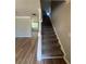 Carpeted staircase with painted white banister leading to the upper level, seamlessly connected to the living area at 2763 Storybook Ct, Grayson, GA 30017