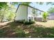 A townhome with green backyard featuring a patch of shade, a patio, and some lush landscaping at 2857 Regal Park # 3, Atlanta, GA 30318
