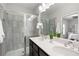 Primary bathroom featuring a double vanity, dark cabinets, and a glass-enclosed shower at 2857 Regal Park # 3, Atlanta, GA 30318