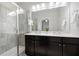 Bathroom featuring a double vanity, dark cabinets, and a glass-enclosed shower at 2857 Regal Park # 3, Atlanta, GA 30318