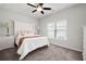 Cozy bedroom with neutral carpet, a ceiling fan, and a window for natural light at 2857 Regal Park # 3, Atlanta, GA 30318
