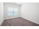 This bedroom features a neutral color palette, cozy carpet, and a bright window at 2857 Regal Park # 3, Atlanta, GA 30318