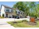 Exterior view of townhomes at The Park at Monroe, featuring attached garages and professionally landscaped front yard at 2857 Regal Park # 3, Atlanta, GA 30318