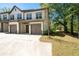 Modern townhome exterior with attached garages and a manicured lawn at 2857 Regal Park # 3, Atlanta, GA 30318
