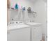 The laundry room has a washer, dryer, and overhead shelving for storage at 2857 Regal Park # 3, Atlanta, GA 30318