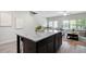 Open living area featuring a kitchen island, an adjacent dining room, and a living room at 2857 Regal Park # 3, Atlanta, GA 30318