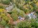 An aerial view shows the home nestled among mature trees in a quiet, wooded neighborhood at 3024 Bob Cox Rd, Marietta, GA 30064