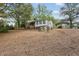 A sprawling backyard area with a charming home, wooden fence, and a convenient carport for parking at 3024 Bob Cox Rd, Marietta, GA 30064