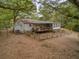 View of the home's rear facade, wooden deck and fenced in yard at 3024 Bob Cox Rd, Marietta, GA 30064