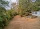 Aerial view of a tranquil backyard with ample space, a charming wooden fence, and a cozy home at 3024 Bob Cox Rd, Marietta, GA 30064