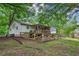 The rear of the home shows a well-maintained deck and landscaped backyard surrounded by greenery at 3024 Bob Cox Rd, Marietta, GA 30064