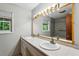 Bathroom featuring double sinks, a large mirror, and a window offering natural light at 3024 Bob Cox Rd, Marietta, GA 30064