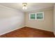 A bedroom with a window for light and classic hardwood floors at 3024 Bob Cox Rd, Marietta, GA 30064