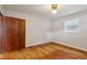 This bedroom features wood floors, neutral paint, a ceiling fan and a window at 3024 Bob Cox Rd, Marietta, GA 30064