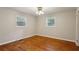 Bedroom featuring two windows that bring in natural light and hardwood floors at 3024 Bob Cox Rd, Marietta, GA 30064