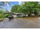 Charming single story home featuring a covered carport and mature trees for added privacy at 3024 Bob Cox Rd, Marietta, GA 30064