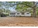 Charming single-story home with vinyl siding and a spacious, tree-filled front yard at 3024 Bob Cox Rd, Marietta, GA 30064