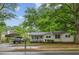 Cozy home with a large, mature tree, carport, and landscaped front yard offers curb appeal at 3024 Bob Cox Rd, Marietta, GA 30064