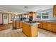 Open kitchen featuring a center island with a cooktop and wood cabinets at 3024 Bob Cox Rd, Marietta, GA 30064