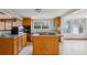Kitchen with center island cooktop, wood cabinets, and natural light at 3024 Bob Cox Rd, Marietta, GA 30064