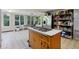 Bright kitchen with stainless steel appliances, island with cooktop, and adjacent sunroom at 3024 Bob Cox Rd, Marietta, GA 30064