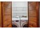 Laundry closet with a front-load washer and dryer, as well as shelving for storage at 3024 Bob Cox Rd, Marietta, GA 30064