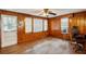 Living room featuring wood paneling, hardwood floors, and ample natural light from large windows at 3024 Bob Cox Rd, Marietta, GA 30064