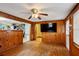 Living room with wood paneling, hardwood floors, and open access to the adjoining kitchen at 3024 Bob Cox Rd, Marietta, GA 30064