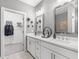 Modern bathroom with dual sinks, white countertops, decorative mirrors, and a walk-in closet at 371 Grant Se Cir # 1822, Atlanta, GA 30315