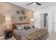 Cozy bedroom featuring brick accent wall, decorative lighting, and ensuite bath access at 371 Grant Se Cir # 1822, Atlanta, GA 30315