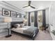 Well-lit primary bedroom with a ceiling fan, modern accent wall, and large windows at 371 Grant Se Cir # 1822, Atlanta, GA 30315