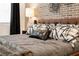 Comfortable bedroom with stylish bedding and a brick accent wall at 371 Grant Se Cir # 1822, Atlanta, GA 30315