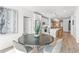 Open concept dining area with sleek black table set, open to a modern kitchen at 371 Grant Se Cir # 1822, Atlanta, GA 30315