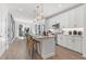 Open-concept kitchen featuring white cabinets, stainless steel appliances, and a marble-topped island with bar stools at 371 Grant Se Cir # 1822, Atlanta, GA 30315