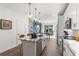 Bright kitchen with white cabinetry, marble countertops, a stainless steel range and a central island with seating at 371 Grant Se Cir # 1822, Atlanta, GA 30315
