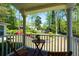 Cozy back porch with an overlooking view of a beautiful yard, surrounded by an abundance of luscious trees and plants at 11050 Linbrook Ln, Duluth, GA 30097