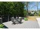 Outdoor deck with stylish furniture overlooks a spacious backyard with privacy landscaping at 11050 Linbrook Ln, Duluth, GA 30097