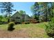 Lush backyard with verdant lawn and mature trees, creating a serene and private outdoor space at 11050 Linbrook Ln, Duluth, GA 30097