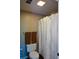 Bathroom featuring a shower with white patterned curtains and two brown towels at 11050 Linbrook Ln, Duluth, GA 30097