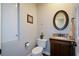 Cozy bathroom with granite countertop, framed oval mirror, and neutral wall color at 11050 Linbrook Ln, Duluth, GA 30097