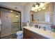 Bathroom features a glass-enclosed shower, vanity with decorative mirror, and tile flooring at 11050 Linbrook Ln, Duluth, GA 30097